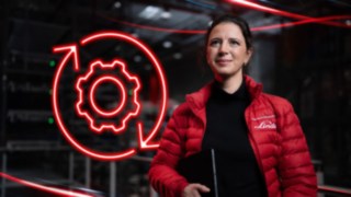 Pracownica firmy Linde Material Handling w magazynie, a w tle czerwona ikona LED przedstawiająca koło zębate.
