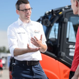 Johannes Kratzel, szef działu Event Support, podczas rozmowy z pomocnikami studenckiej formuły przy wózku firmy Linde Johannes Kratzel, szef działu Event Support, podczas rozmowy z pomocnikami studenckiej formuły