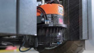 Czujniki znajdujące się blisko podłoża są automatycznie czyszczone sprężonym powietrzem. Czujnik przy poziomie podłoża autonomicznego wózka z przeciwwagą.